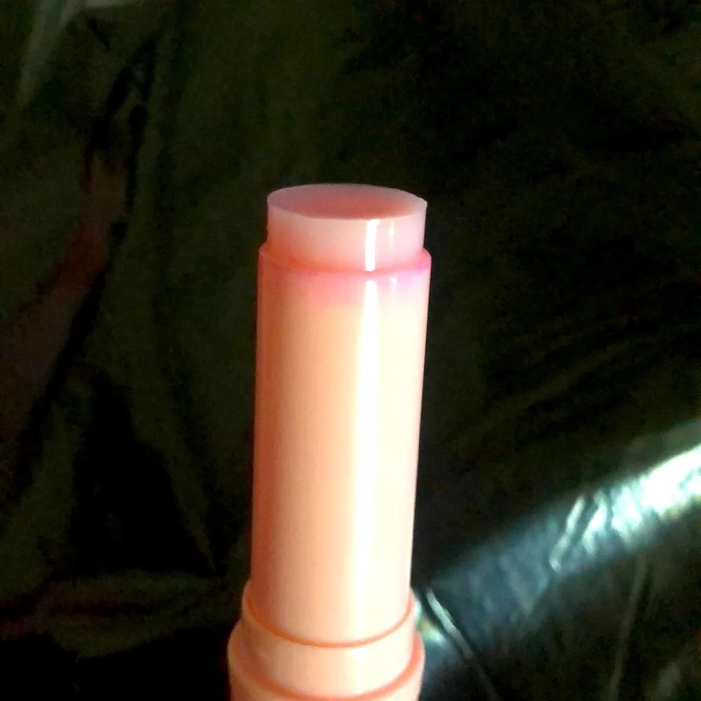 Ten peach-colored lip balms
